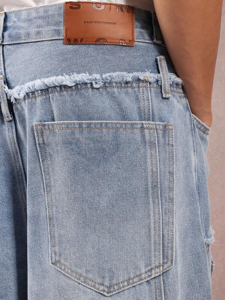Asymetryczne jeansy z szerokimi nogawkami i postrzępioną talią