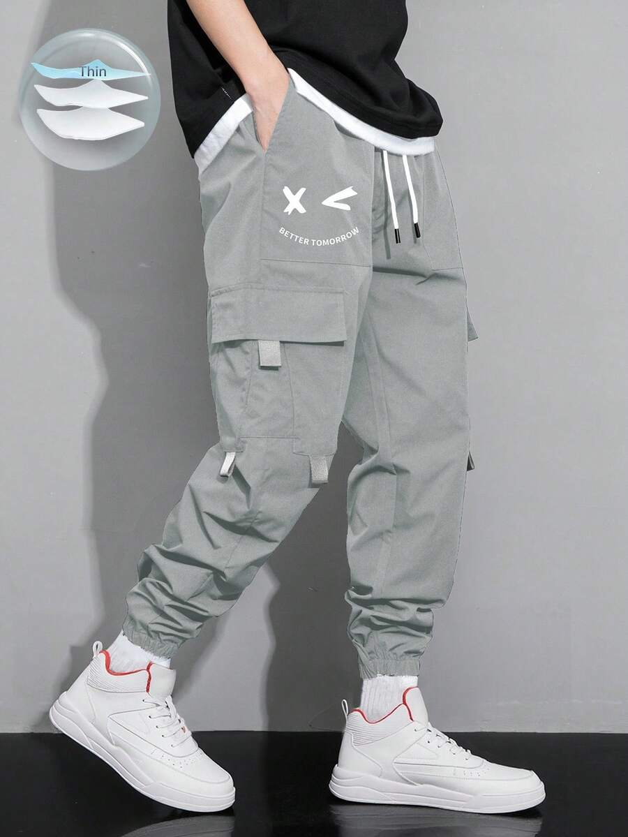 Claim Dot Pantalones cargo con estampado de expresión, bolsillo con solapa y cordón en la cintura, para otoño - Gris Claro - Ver 1