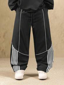 SUMWON Pantalones de chándal con detalles de rayas de contraste en los paneles laterales, fondo deportivo clásico de pierna ancha con cordón, bolsillos laterales, ropa urbana y deportiva de otoño e invierno, estilo moderno de ocio activo - Negro - Ver 1