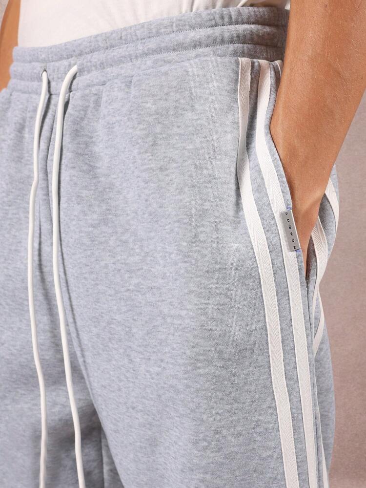 Melanżowe spodnie dresowe z potrójnymi paskami po bokach i elastycznymi mankietami