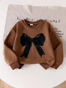 SHEIN Elladie kids 两件套女童棕色蝴蝶结印花长袖上衣搭配黑色喇叭裤套装，可爱舒适的卫衣套装，适合春秋冬季穿着。