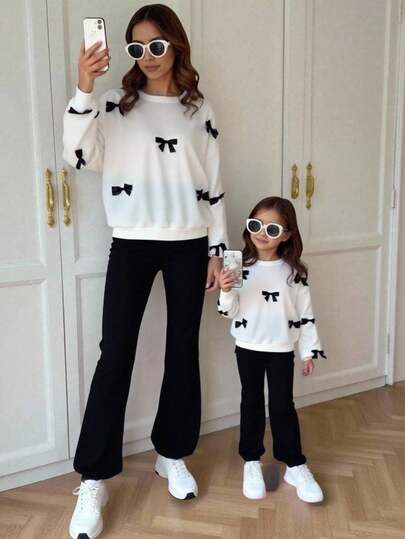 SHEIN 年轻女孩宽松大码蝴蝶结、拼色蝴蝶结装饰贴花运动衫和修身喇叭裤套装，适合户外、学校日常穿着。返校季、秋冬、温暖舒适的秋季服装，非常适合秋冬季休闲、日常穿着和学校日常穿着，适合圣诞节、女孩冬装、圣诞服装、派对服装、日常学校服装、生日服装、公主服装、妈妈和女儿和姐妹搭配，