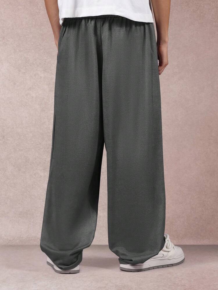 Pantalon de survêtement à jambes larges avec bandes latérales