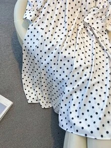 Franclia 2025新款秋季女式长裙：复古波尔卡圆点在面料上飘逸舞动，大大小小的圆点编织出活泼有节奏的图案。挺括的方形领口低调优雅地勾勒出纤细的颈部和锁骨，仿佛精心雕琢以凸显柔和的曲线。腰部和下摆的褶皱轻柔收拢，像涟漪一样折叠成层层褶皱，轻柔而又独特，赋予裙子柔和飘逸的造型。灯笼状的泡泡袖从肩部绽放，袖口轻轻收紧，一丝俏皮在哼唱复古曲调的同时平衡了秋天的舒适感。优雅中带着一丝少女的甜美，从通勤到约会之夜都可轻松驾驭，散发着独特的静谧魅力。