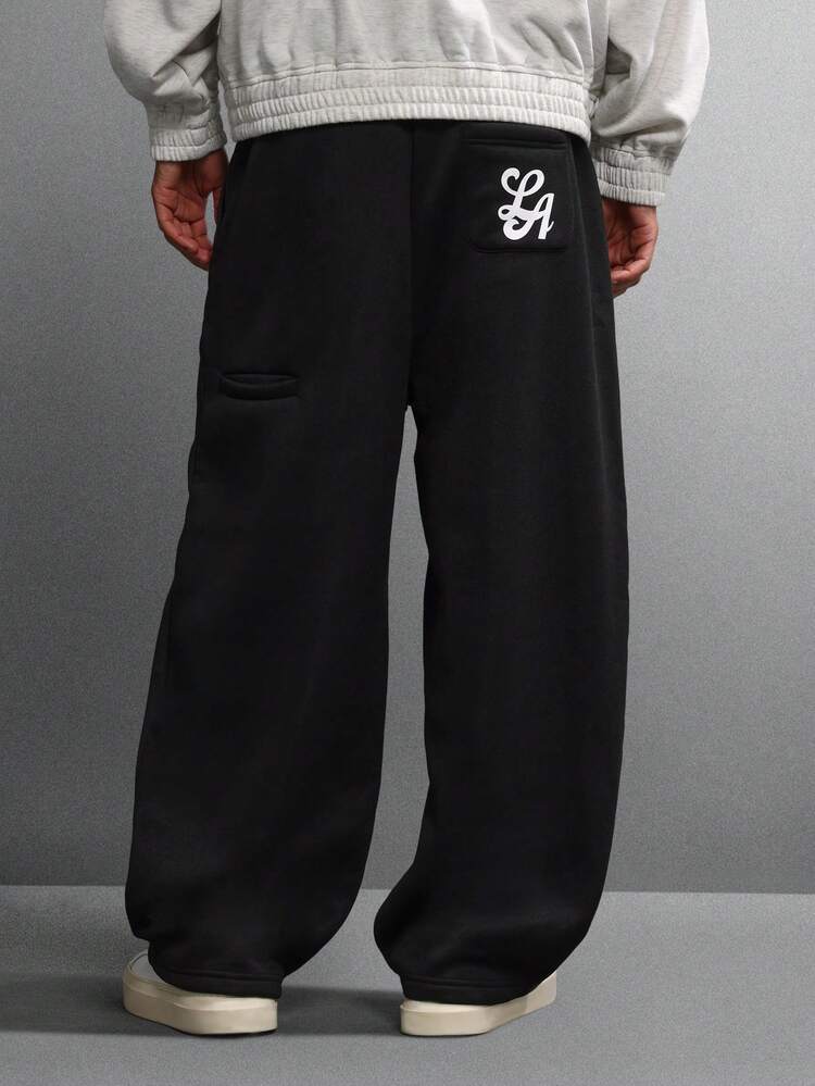Calça de moletom de perna larga com logotipo bordado e bolsos laterais
