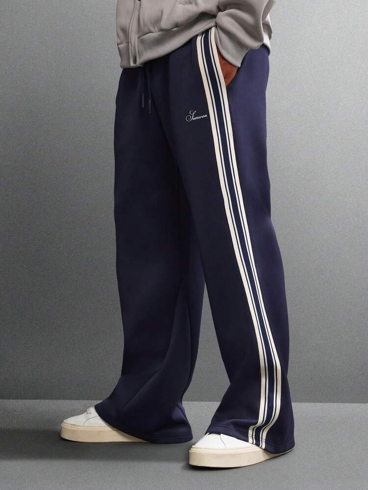 Spodnie dresowe z szerokimi nogawkami, paskami po bokach i logo