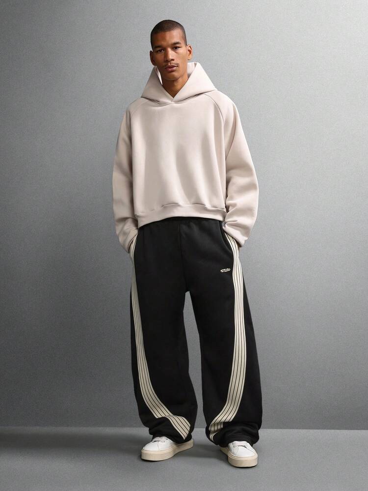 Pantalon de survêtement à jambes larges avec détails à rayures latérales