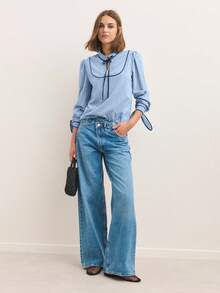 Nöista Blusa de manga larga a rayas con ribete de contraste y un suave cuello con volantes - Una elegante y chic blusa de otoño/invierno. Las rayas verticales y un cuello con lazo le dan un toque refinado y ligeramente vintage, mientras que las suaves mangas abullonadas y los puños recogidos crean una silueta pulida ideal para combinar con otras prendas.