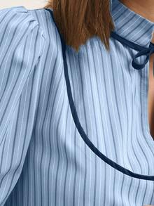 Nöista Blusa de manga larga a rayas con ribete de contraste y un suave cuello con volantes - Una elegante y chic blusa de otoño/invierno. Las rayas verticales y un cuello con lazo le dan un toque refinado y ligeramente vintage, mientras que las suaves mangas abullonadas y los puños recogidos crean una silueta pulida ideal para combinar con otras prendas.