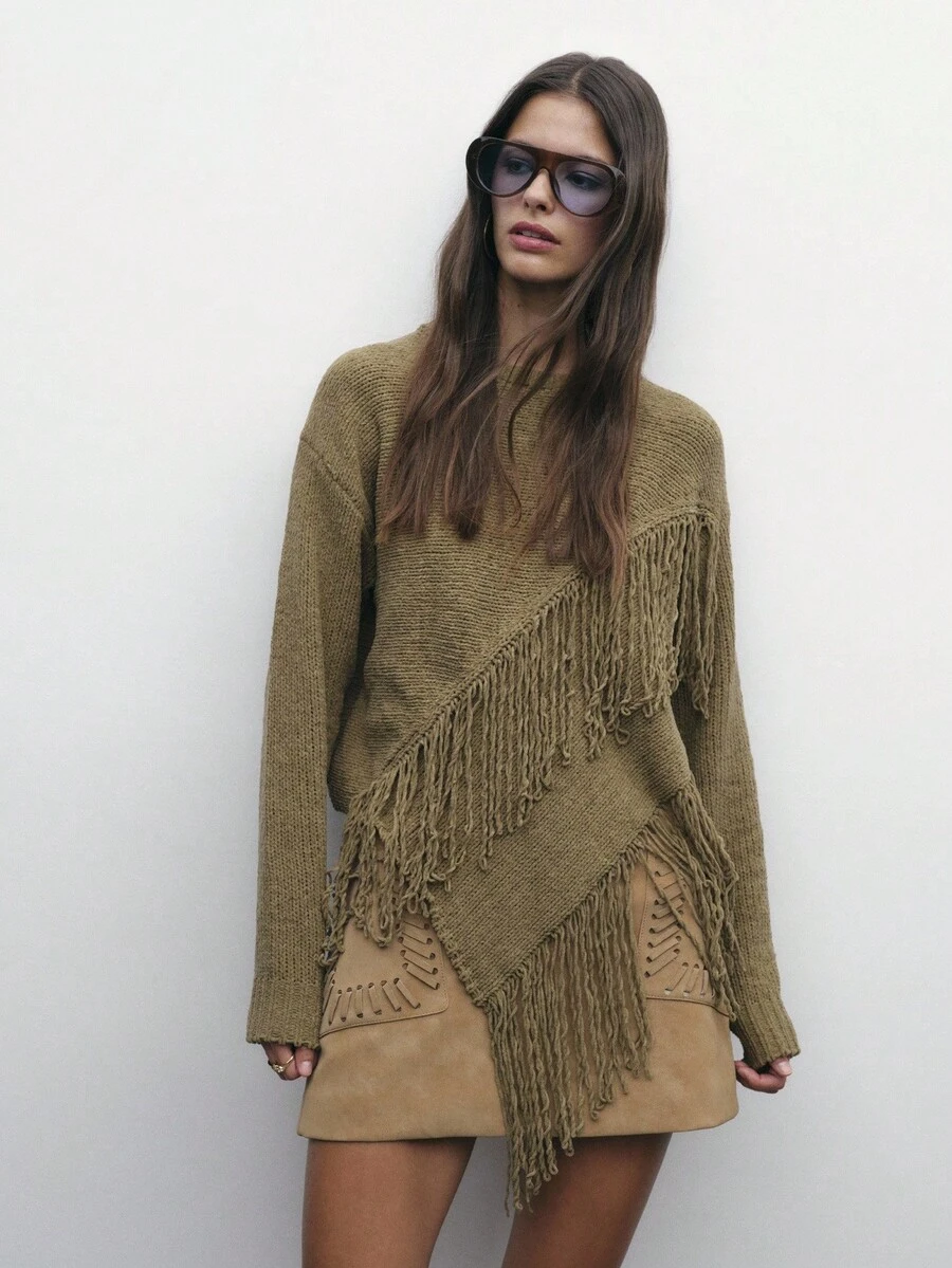 Nöista 这款针织毛衣采用斜向流苏细节和不对称下摆设计，为女性冬季提供大胆而舒适的选择；非常适合搭配牛仔裤或裙子，打造别致的季节造型、节日圣诞造型和现代新年装扮。 - 軍綠色 - 查看 1
