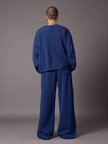 Quần thể thao ống rộng SUMWON, kiểu dáng thoải mái, chất liệu nỉ, có dây rút ở eo và túi bên hông, thích hợp cho mùa thu đông. - Màu xanh lam - Xem 4