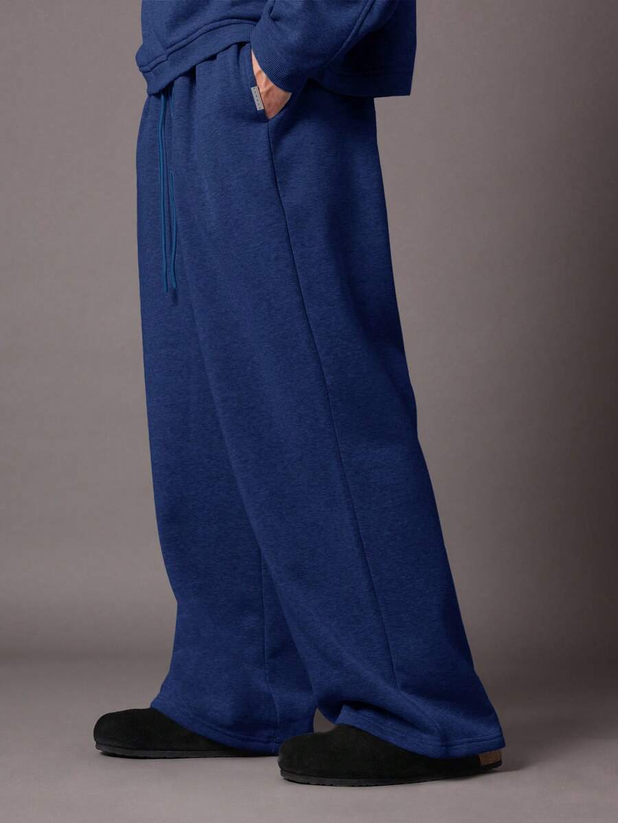 Quần thể thao ống rộng SUMWON, kiểu dáng thoải mái, chất liệu nỉ, có dây rút ở eo và túi bên hông, thích hợp cho mùa thu đông. - Màu xanh lam - Xem 1