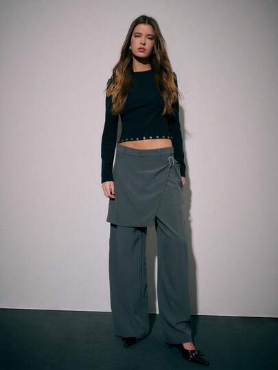 Nöista 灰色阔腿裤，配有叠层裙摆和侧边搭扣细节。优雅的女士下装，完美打造正式场合、时尚街头风或精致的冬季日常穿搭。可轻松搭配衬衫、露脐上衣或冬季外套，打造节日或新年造型。