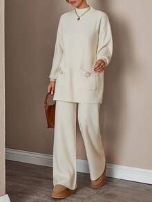 Completo donna con top a collo alto a maniche lunghe e pantaloni, tinta unita