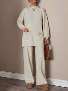 Completo donna con top a collo alto a maniche lunghe e pantaloni, tinta unita