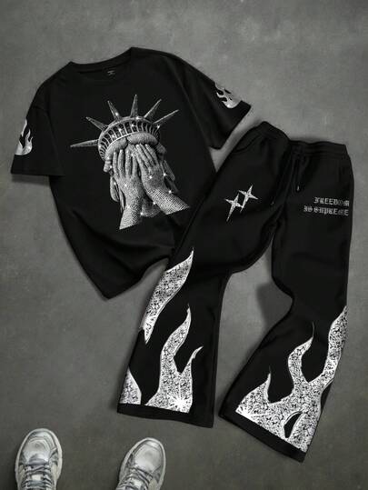 Manfinity EMRG 2pcs Men's Round Neck Short Sleeve T-Shirt And Drawstring Pants Set,Fashionable Now Freedom Soul Black Set | Hip-Hop NYC Liberty Statue Graphic Tee + Flame Pattern Pants | Ultra Comfortable Loose Fit | Dark Aesthetic Couple Outfit | Street Photography Essential