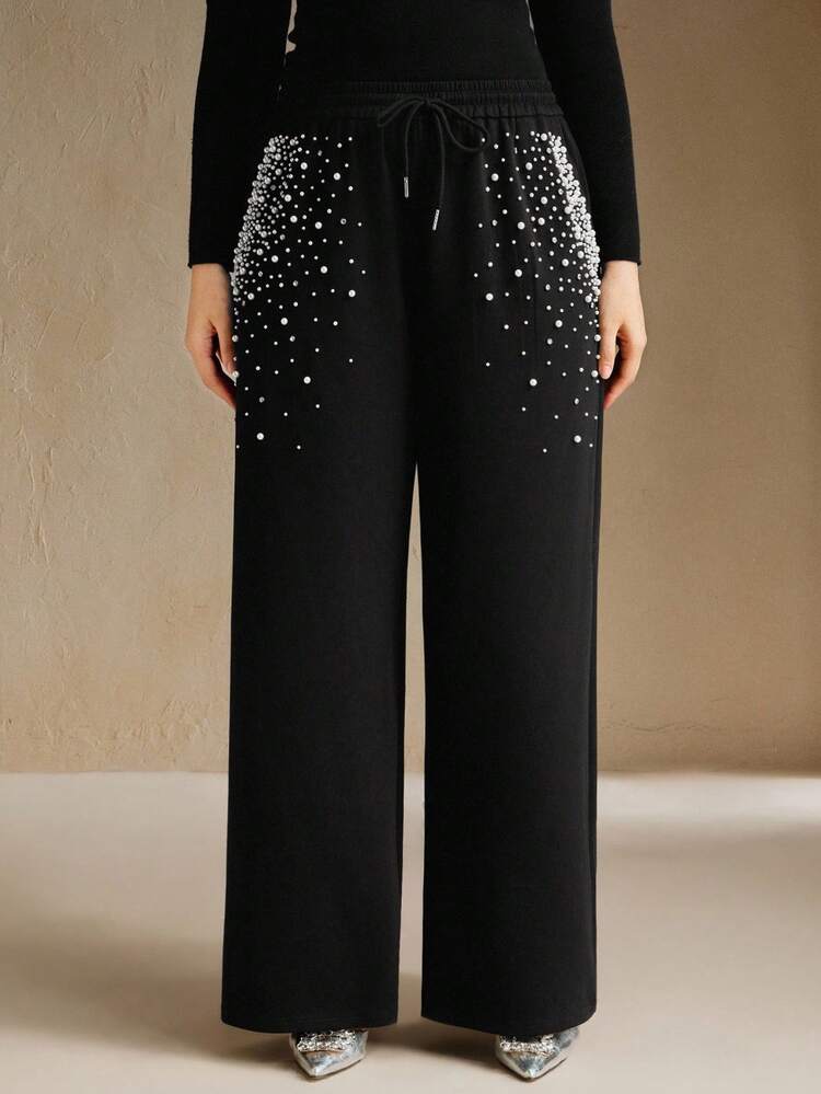 Pantaloni della tuta lunghi neri moderni e molto decorati con perline per donna