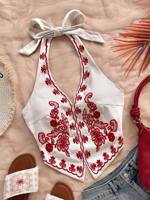 Soleia Top corto con cuello halter, espalda descubierta y lazo, con bordado floral sobre base color albaricoque, adecuado para festivales de música