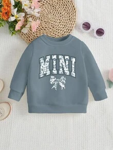 SHEIN Playful Pals Sweatshirt für Kleinkind Mädchen, lässige Mode mit kreativer Schleife, Blumen-Grafik, Slogan-Aufdruck, Rundhalsausschnitt, Herbstoutfit