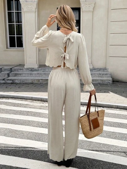 SHEIN Frenchy Fall Winter 2025 2pcs Women Casual Commuter Simple Solid Color Ruffle Sleeve Twist Back Cropped Top And Wide Leg Pants Set, Spring/Autumn, Beige Two Piece Set,Cream Two Piece Set, Comfortable Two Piece Set,Two Piece Set Women Comfy, Elegant Two Piece Set, Modest Two Piece Set, Long Sleeve Elegant Top, Elegant Wide Leg Pants,Back Bow Knot Top And Pants Two-Piece Set, Wavy Hem Shirt And Straight-Leg Pants Two-Piece Set,Fashionable & Versatile,Luxury Clothes For Women, Christmas Outfit For Women,New Year Outfit,Thanksgiving Outfit For Women,Setup Autumn Winter Women , Cozy Fall And Winter Clothes For Women ,French Style Clothes, Brunch Outfit, Elegant Women's Set ,Commuting, Office , Minimalist, Elegant, Vintage, Perfect For Everyday Outfits, French Fashion Style,Beach Set