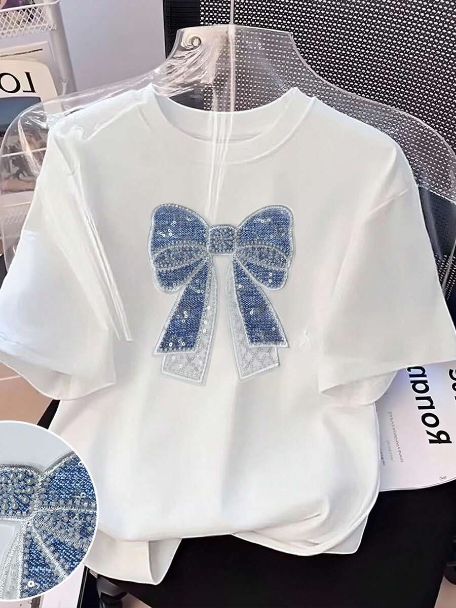 Resyla Áo thun cổ tròn thêu họa tiết nơ ngọc trai cỡ lớn cho nữ - trắng - Xem 1