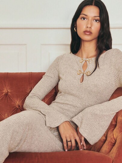 Nöista Full-Length Beige Ribbed Knit Dress With Long Flared Sleeves And Decorative Loop Closures Over A Front Keyhole; Fitted Through The Body With A Subtle Flare, Offering Soft Stretch Ideal For Fall And Winter Wear And Polished Enough For Christmas Or New Year Gatherings.