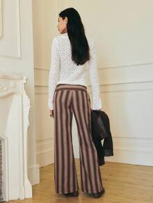 Nöista Muted Tones And Soft Vertical Lines Offer A Refined Silhouette With A Flared Leg. Styled With A Brown Sweater Or Going Out Tops For Women, It Pairs Well With Elegant Blouses For Women During Fall And Autumn.
