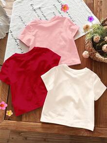 SHEIN 3 pièces T-shirts à col ras du cou manches courtes décontractés pour bébés filles avec des motifs de Noël mignons comme amande crème, rose crème, rouge de Noël, célébration de dessin animé, bonhomme de neige amusant, flocon de neige, Père Noël, convenant pour toutes les saisons - Multicolore - Voir 2