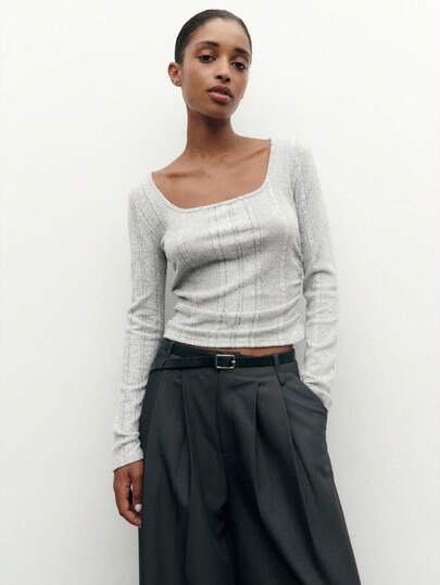 Nöista Grey Ribbed Knit Cropped Top With A Square Neckline And Long Sleeves, Offering An Elegant And Figure-Enhancing Look Ideal For Stylish Winter Layering And Casual Chic Urban Outfits For Women, Perfect For Pairing With Coats, Skirts Or High-Waisted Trousers For Polished Christmas And New Year Styling.