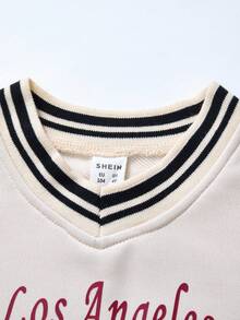 一套女童运动休闲套装，包含一件印有“洛杉矶79”字样的棒球夹克和一条浅蓝色阔腿裤，厚度适中，适合日常穿着，春秋/秋冬季皆宜。 - 杏色 - 查看 4