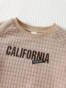 Cozy Pixies Klassischer Babypullover mit Karomuster, Jacquard-Stoff, gesticktem Buchstabenmotiv, Rundhalsausschnitt und langen Ärmeln – ideal für Jungen und Mädchen. Perfekt für Herbst und Winter. Auch als Babypullover Einfarbig erhältlich. Unisex-Kleidung. - Aprikosenfarben - Übersicht 5