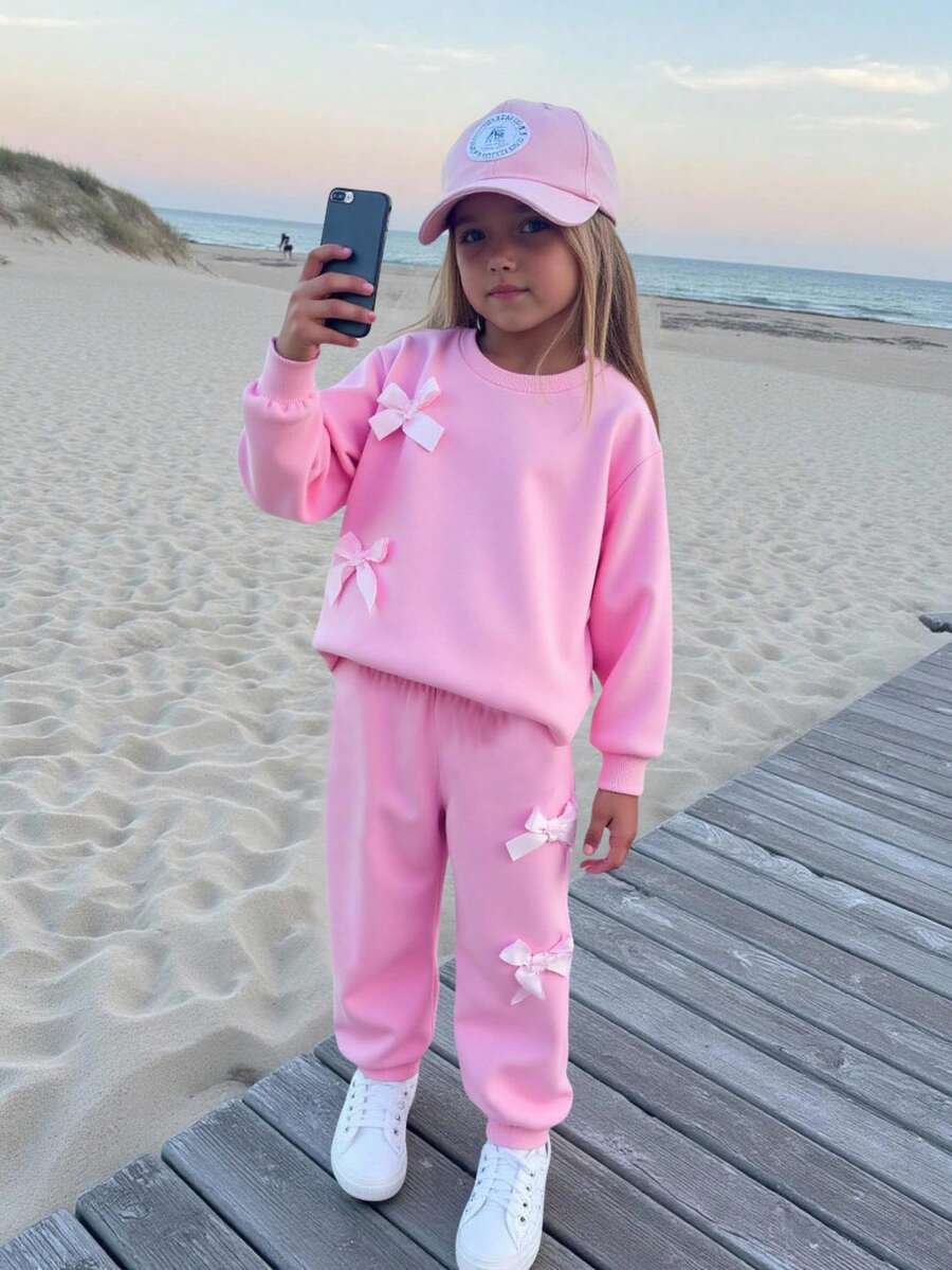 SHEIN Playful Pals 2pcs/Set Young Girls Fashion Pink Bow Round Neck Long Sleeve Sweatshirt And Elastic Waist Jogger Pants, Casual Sporty Outfit Suitable For Spring And Autumn Girls Jogging Set Girls Sweatsuit Set Girls Comfy Set Toddler Girl Sweatsuit Girls Bow Set Fall Winter
