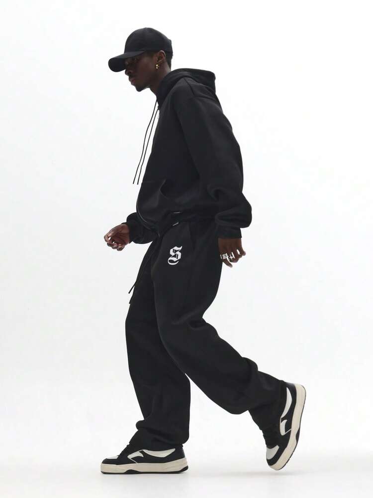 Calça de moletom com logotipo gótico e ajuste solto, com tornozelos elásticos