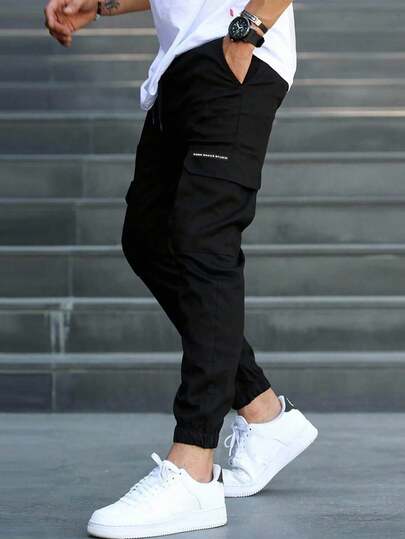 Manfinity Homme Pantaloni joggers cargo casual pentru bărbați, mărimi mari, cu grafică scrisă și șnur în talie, pantaloni negri casual, streetwear, toamnă