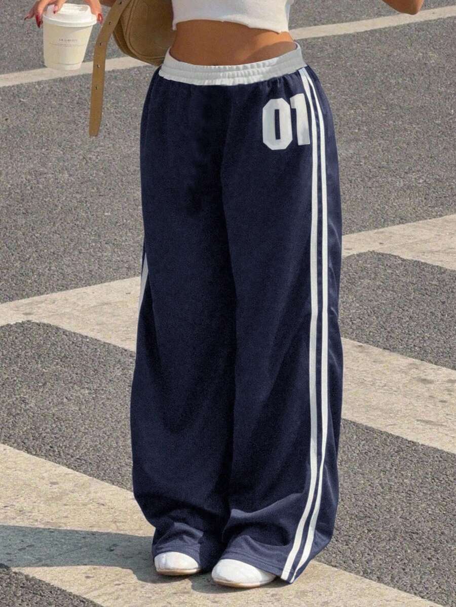 SHEIN Spodnie dresowe dla dziewcząt z nadrukiem "Wracamy do szkoły" w kontrastowym kolorze, z elastyczną talią i sznurkiem ściągającym, z nadrukiem numerycznym, luźne, proste nogawki, uniwersalne i modne - Granatowy - Zobacz 1