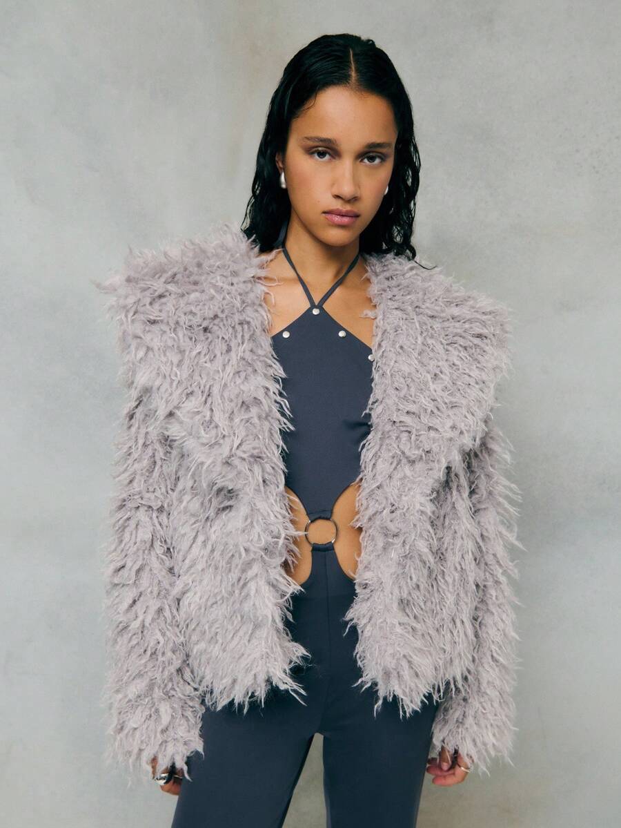 TypaGal Cozy And Glamorous, This Gray Jacket Features Plush Faux Fur With A Voluminous Texture For Warmth And Style. Perfect For Layering Over Evening Or Casual Outfits, This Gray Coat Adds Instant Luxury To Your Winter Wardrobe.