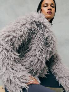 TypaGal Cozy And Glamorous, This Gray Jacket Features Plush Faux Fur With A Voluminous Texture For Warmth And Style. Perfect For Layering Over Evening Or Casual Outfits, This Gray Coat Adds Instant Luxury To Your Winter Wardrobe.