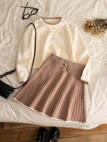 Sparklyn 2 件套可爱女孩杏仁白色针织上衣和浅棕色百褶裙，饰有精致的钻石图案和蝴蝶结装饰，适合春秋季、秋冬季节，非常适合学校、派对、家庭活动