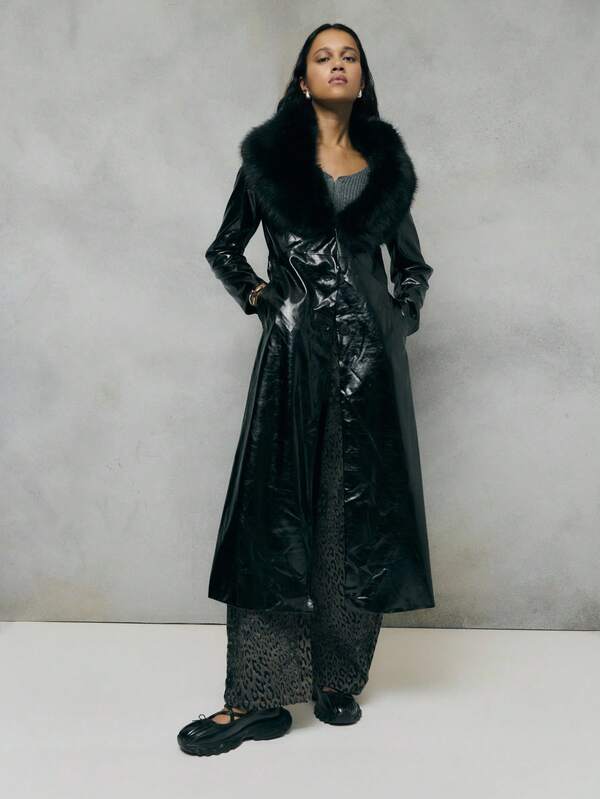 TypaGal This Black Coat Features A Glossy Faux-Leather Finish With A Dramatic Faux-Fur Collar And Waist Belt. Sleek And Luxurious, It's A Statement Black Trench Coat For Women, Perfect For Adding Elegance And Edge To Winter Outfits.