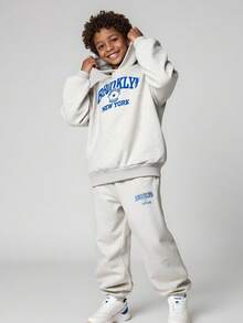 JNSQ Tween Jungen Outfit Set mit 2 Teilen: Locker sitzender Farbblock Buchstaben-Muster Kapuzenpullover Top und Relaxed Fit Jogginghose Unterteil, geeignet für Herbst, Winter, Alltag, Outdoor-Aktivitäten, Urlaub, Streetwear, Party und Lässig