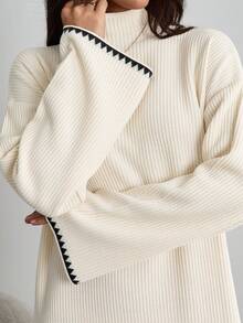 EURMUSE Elegant Cream Ribbed Knit Maxi Dress With Mock Neck And Subtle Black Contrast Wave Hem – Minimal Winter Statement Piece Elegant Cream Rib Knit Maxi Sweater Dress With Contrast Trim And Belted Waist For Minimal Chic Fall Looks - Beige - View 2