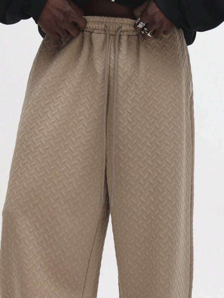 Calça texturizada de perna larga com cordão na cintura