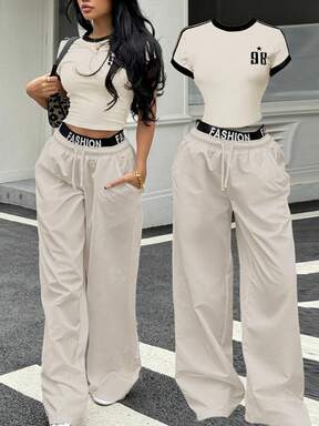 SHEIN Conjunto de dos piezas de estilo deportivo y callejero retro estadounidense para adolescentes, con camiseta de manga corta de color contrastante y pantalones anchos y holgados