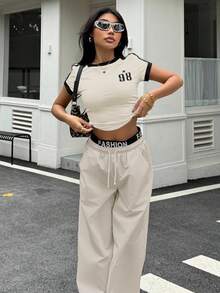 SHEIN Conjunto de dos piezas de estilo deportivo y callejero retro estadounidense para adolescentes, con camiseta de manga corta de color contrastante y pantalones anchos y holgados