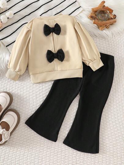 SHEIN 2 件套女婴可爱杏色蝴蝶结装饰运动衫和黑色喇叭裤套装，时尚百搭