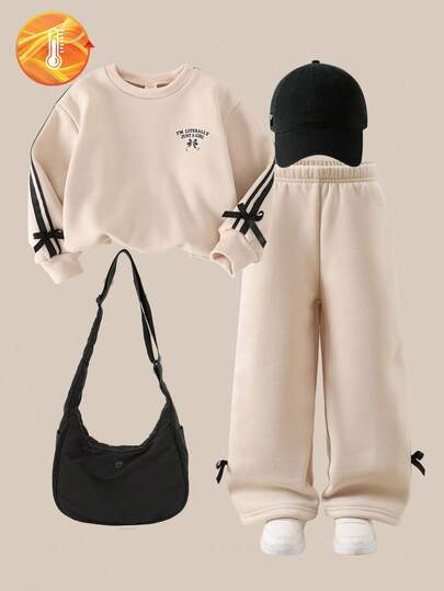 SHEIN Explorewe 2 Pieces Set Of Autumn/Winter Sweatshirts For Little Girls. The Set Includes A Casual And Simple Long-Sleeved Crew-Neck Top With Bowknot Ribbons And No Hood, And A Pair Of Bowknot Long Pants. It Is A Suit For Little Girls.