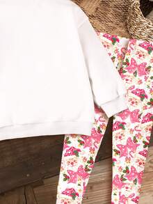SHEIN Bộ đồ Giáng Sinh Happikins, màu hồng Giáng Sinh, ông già Noel hoạt hình dễ thương, họa tiết nơ in hình báo hồng, không khí Giáng Sinh kẹo gậy, quà tặng Giáng Sinh, bộ 2 món áo nỉ dài tay cổ tròn và quần legging cho bé gái, thích hợp cho mùa thu/đông, ở nhà, trang phục dự tiệc Giáng Sinh. - Nhiều màu - Xem 6
