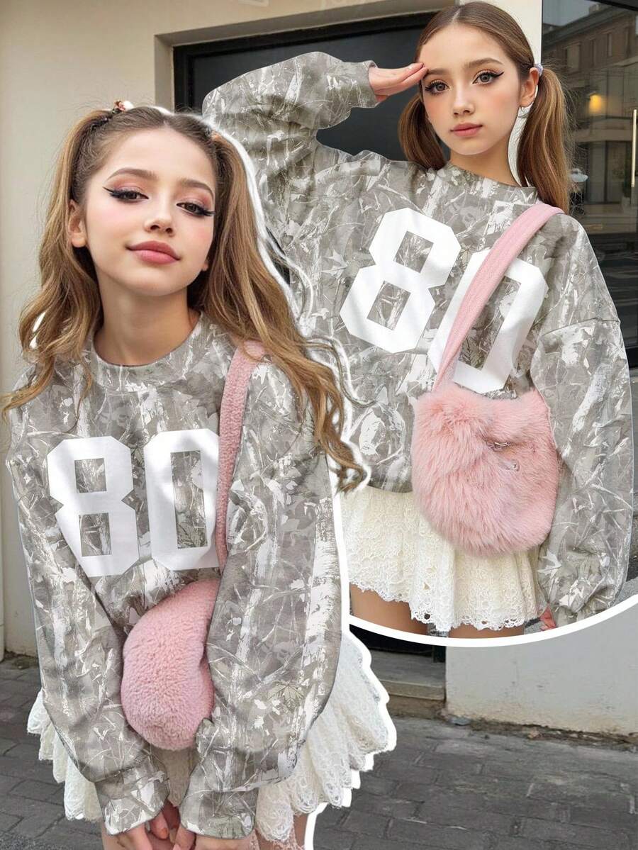 SHEIN 这款少女休闲宽松圆领长袖卫衣,印有数字80,采用迷彩和枯叶图案设计,舒适百搭,适合少女穿着,展现学院风、街头风、户外野餐、街头摄影、居家、波西米亚风、音乐节以及秋冬季节的穿搭需求。 - 彩色 - 查看 1