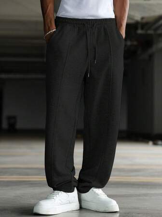 Manfinity Hypemode Svarta enfärgade mjukisbyxor med dragsko för män, med stickat tyg, raka ben och praktiska fickor, perfekta för gym och utomhusaktiviteter. Herr Svarta mjukisbyxor Herr Baggy mjukisbyxor för män Jogger Designer-mjukisbyxor för män