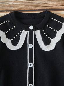 SHEIN Playful Pals Young Girl Casual And Cute Black Knitted Long-Sleeved Cardigan With Pearl Contrast Color And A Ruffled Knitted Short Skirt. Soft And Comfortable, Suitable For Daily Occasions, Outdoor Scenes, Travel Scenes, Vacation Scenes, Home Scenes, Nursery Scenes, And Children Playing - Black - View 9